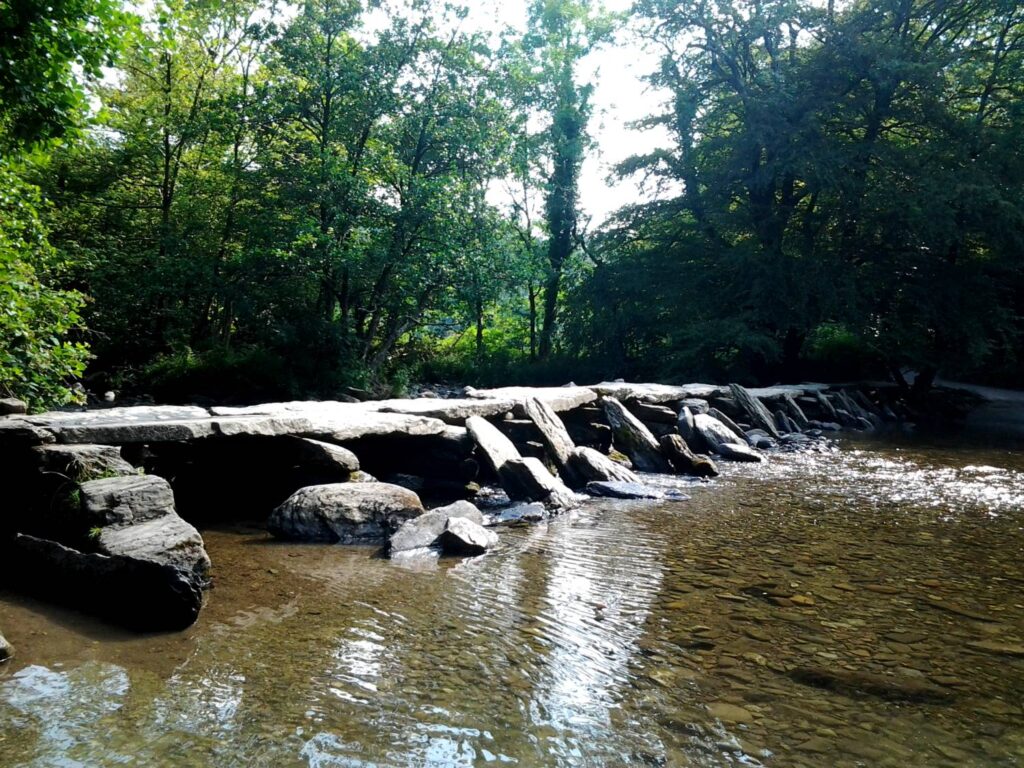 Historic Tarr Steps clapper bridge crossing the River Barle in Exmoor National Park