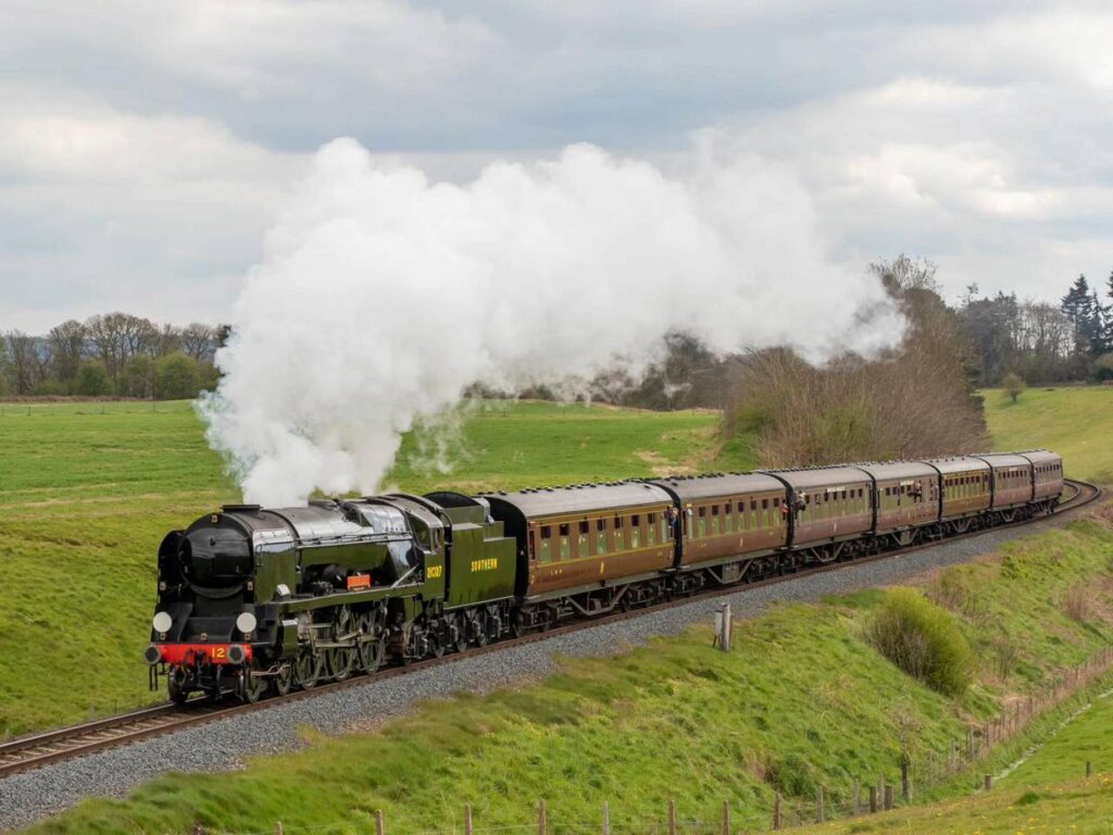 West Somerset Railway heritage steam train travelling through the countryside near Exmoor National Park