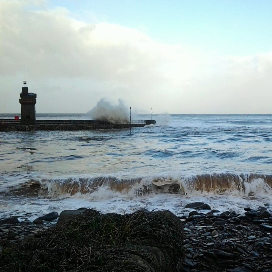 Winter waves crash against Lynmouth harbour wall on the Exmoor coast